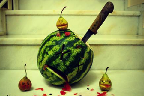 Watermelon stabbed with knife with x's for eyes