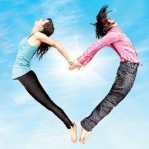 two people jumping up and forming a heart with their bodies