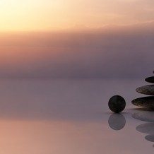 balancing rocks sitting in shallow water